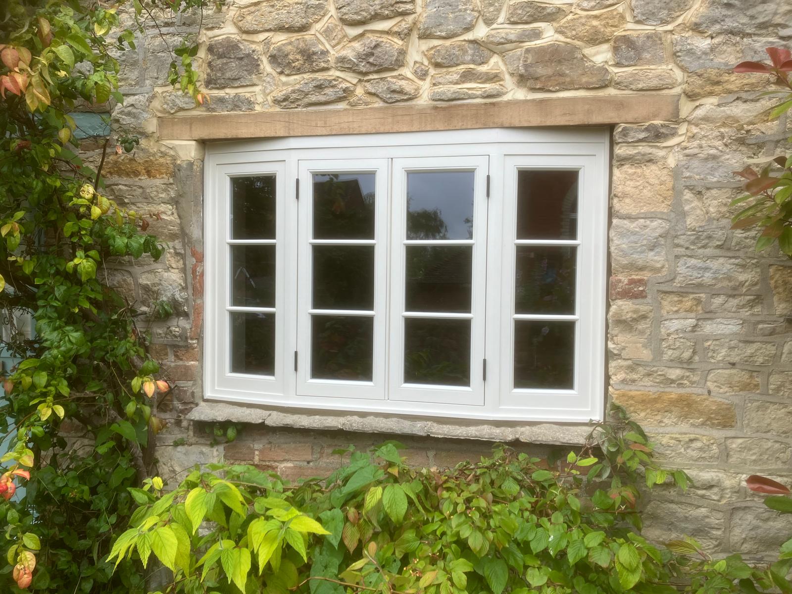 White uPVC casement windows fitted in a stone cottage
