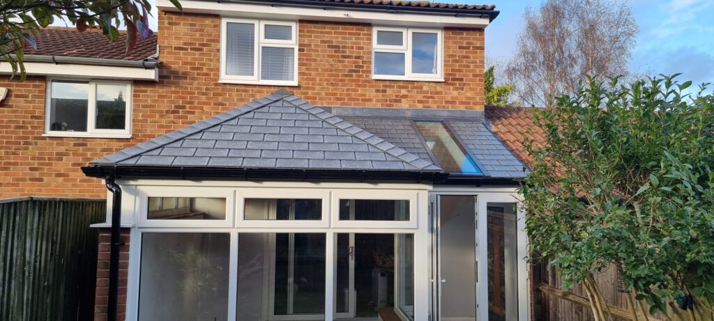Tiled-roof conservatory on a brick house