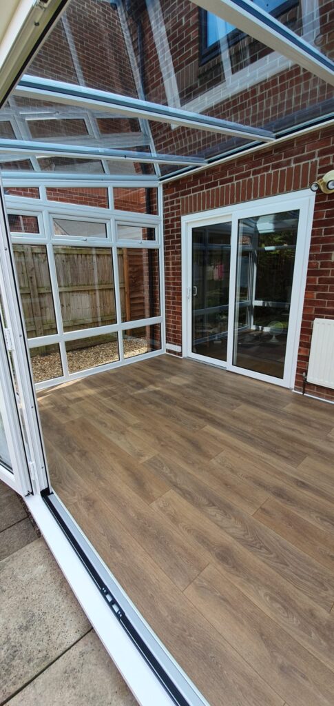 White uPVC conservatory windows on a brick house