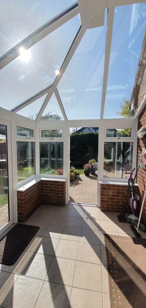 White uPVC French doors with side windows opening to a garden
