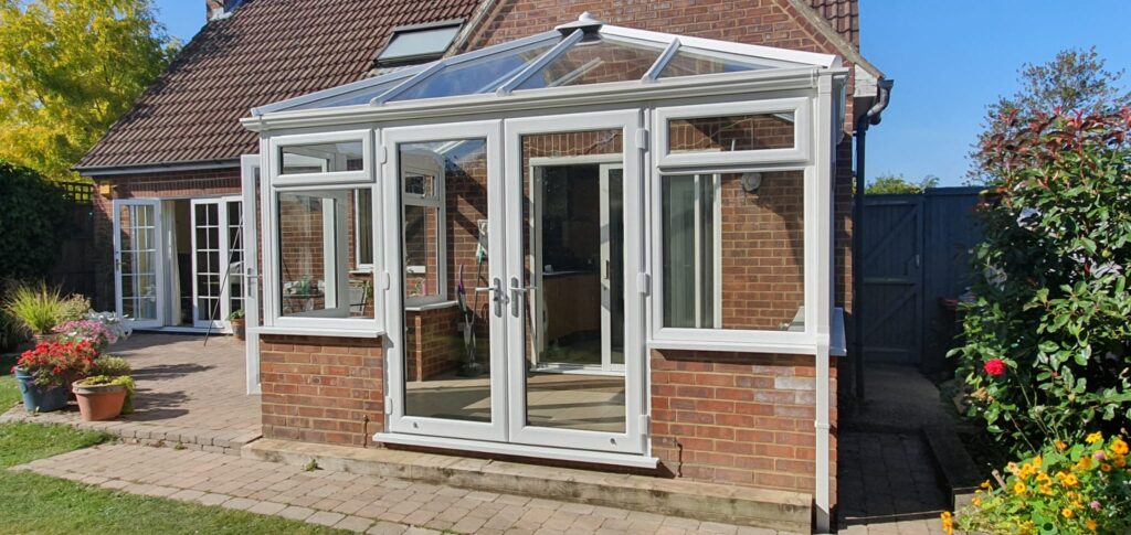 White uPVC windows fitted in a single-storey brick extension