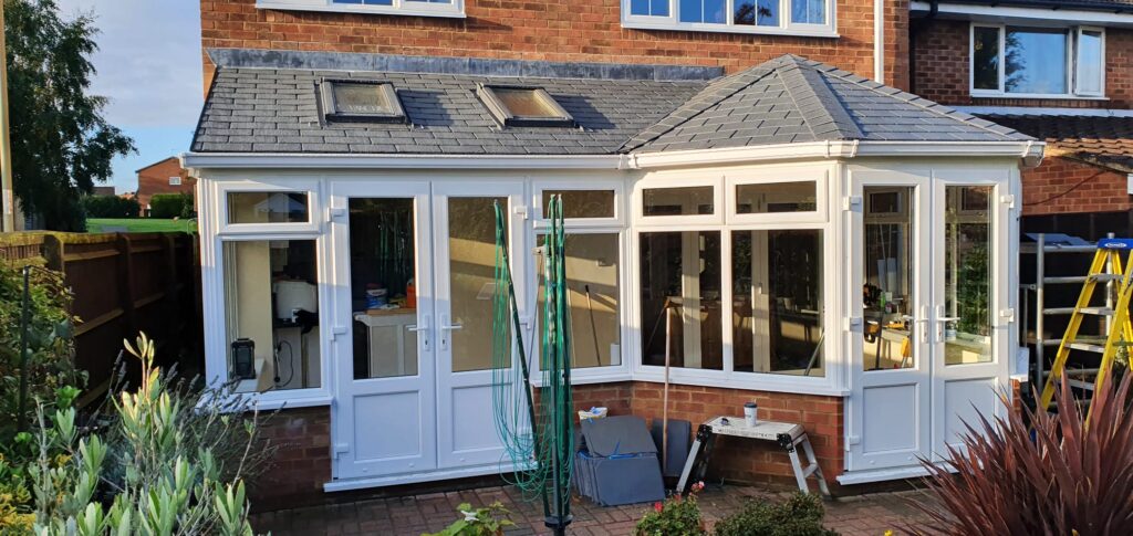 White uPVC orangery under construction with glazed roof