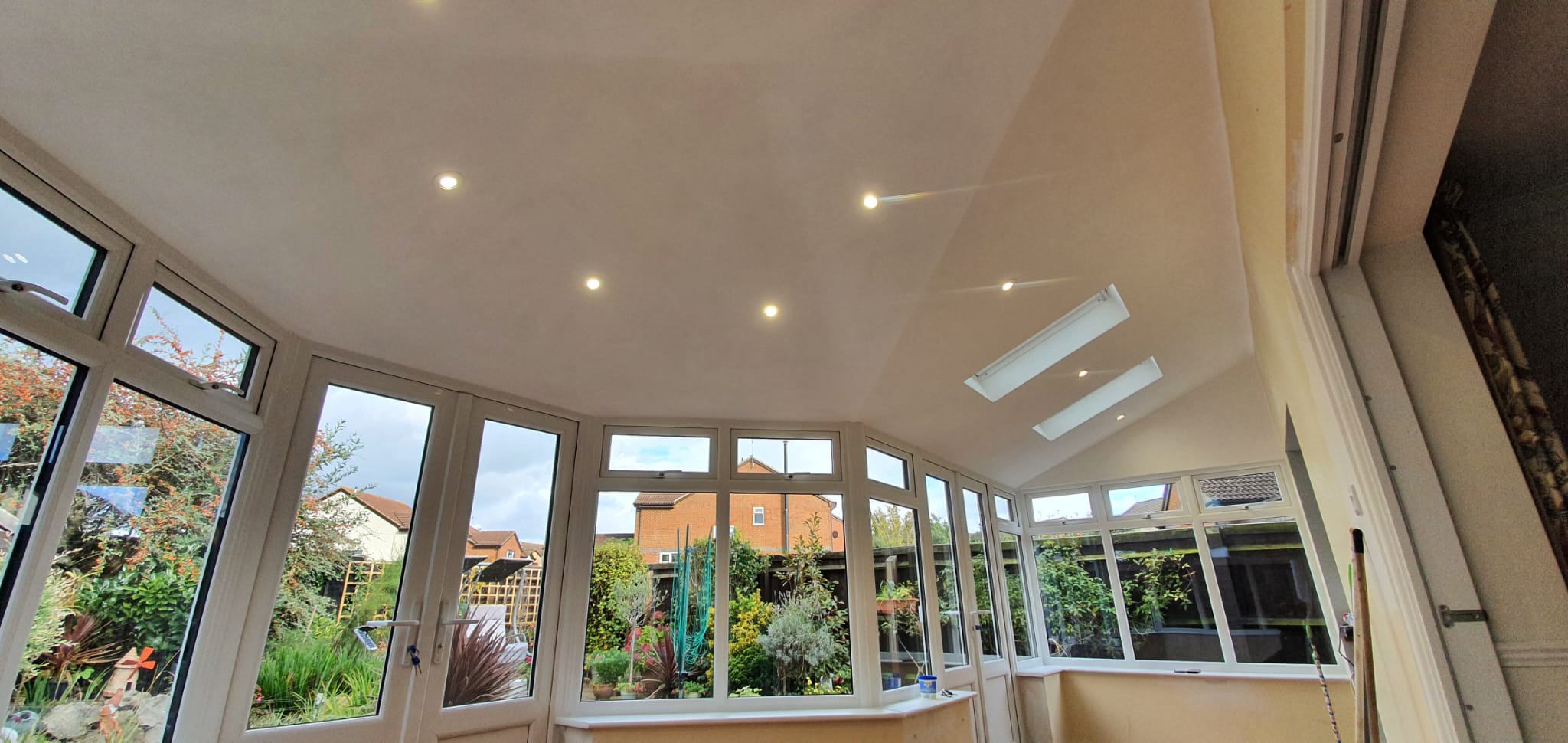 Interior of a conservatory with a vaulted glazed roof