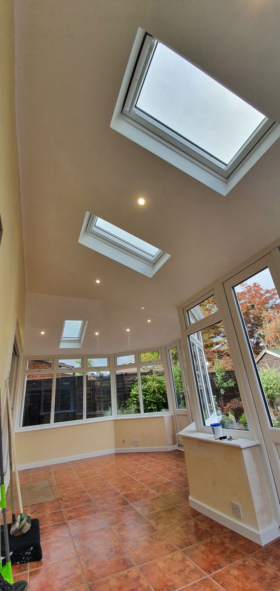 Interior of a conservatory with a vaulted glazed roof and rooflights